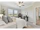 Light-filled bedroom features plush carpet, ceiling fan, and stylish furnishings at 31675 Cannon Rush Dr, San Antonio, FL 33576