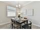 Well-lit dining area with a modern table set, pendant lighting, neutral decor and tile floors at 31675 Cannon Rush Dr, San Antonio, FL 33576