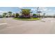 Landscaped roundabout with palm trees and colorful flowers at the entrance to the Medley community at 31675 Cannon Rush Dr, San Antonio, FL 33576