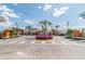 Community entrance to Medley with lush landscaping, stone sign, and palm trees, creating a welcoming atmosphere at 31675 Cannon Rush Dr, San Antonio, FL 33576