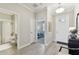 Bright entryway featuring tile floors, a bathroom to the left and an open view into a bedroom at 31675 Cannon Rush Dr, San Antonio, FL 33576