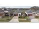 Street view showcasing single-Gathering homes with brick driveways, palm trees, and mature landscaping in a residential neighborhood at 31675 Cannon Rush Dr, San Antonio, FL 33576
