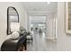 Inviting hallway with tiled floors, a modern table and mirror, and a view into the living room at 31675 Cannon Rush Dr, San Antonio, FL 33576