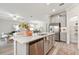 Spacious kitchen island with a stainless steel sink, stainless steel dishwasher and a view into living area at 31675 Cannon Rush Dr, San Antonio, FL 33576