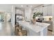 Kitchen featuring stainless steel appliances, quartz countertops, and three counter stools at 31675 Cannon Rush Dr, San Antonio, FL 33576