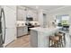 Modern kitchen with stainless steel appliances, quartz countertops, and a convenient breakfast bar at 31675 Cannon Rush Dr, San Antonio, FL 33576