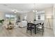 Bright, open-concept living and dining area featuring modern decor, tile floors and lots of natural light at 31675 Cannon Rush Dr, San Antonio, FL 33576
