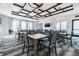 Well-lit meeting room with multiple tables, chairs, stylish ceiling and elegant light fixtures at 31675 Cannon Rush Dr, San Antonio, FL 33576