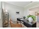 Bright home office with a view, modern desk, stylish decor, and view into the kitchen at 31675 Cannon Rush Dr, San Antonio, FL 33576