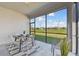 Enclosed patio with dining table set and scenic backyard views for outdoor relaxation and entertaining at 31675 Cannon Rush Dr, San Antonio, FL 33576