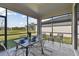 Inviting screened patio with a dining table and outdoor seating overlooking the backyard at 31675 Cannon Rush Dr, San Antonio, FL 33576