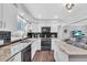 Updated kitchen featuring white cabinets, sleek appliances, and a marble countertop island at 3933 60Th N St, St Petersburg, FL 33709