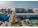 Aerial view of a beachfront property highlighting its proximity to the ocean and nearby residential buildings at 40 140Th E Ave, Madeira Beach, FL 33708