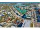 Aerial view of a property with a backdrop of a bay featuring docks and boats in a coastal neighborhood at 40 140Th E Ave, Madeira Beach, FL 33708