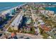 Aerial view of a beachside property featuring residential buildings, and a pool in a vibrant coastal community at 40 140Th E Ave, Madeira Beach, FL 33708