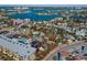 Aerial view showcasing property near a bay with boats, surrounded by residential buildings in a coastal community at 40 140Th E Ave, Madeira Beach, FL 33708