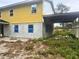 Side view of a two-story home with siding and construction materials in the yard at 4004 27Th Se St, Ruskin, FL 33570