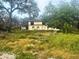 Wide exterior of the house with a yard full of tall grass and weeds at 4004 27Th Se St, Ruskin, FL 33570