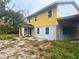 Exterior side view of a two-story home with yellow siding, and visible construction at 4004 27Th Se St, Ruskin, FL 33570