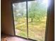 Sliding glass door looking out on the spacious backyard with a large tree at 4004 27Th Se St, Ruskin, FL 33570