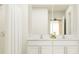 Elegant bathroom featuring a double vanity, granite countertops, and modern fixtures at 4006 Northern Key Dr, Plant City, FL 33563