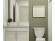 Bathroom featuring a modern vanity with granite countertop, white cabinets, and stylish wall art at 4006 Northern Key Dr, Plant City, FL 33563