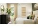 Light-filled bedroom with a large window, elegant dresser, and modern decor at 4006 Northern Key Dr, Plant City, FL 33563