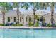 Up close community pool with palm trees, white pergola, lounge chairs, and a pool lift for accessibility at 4006 Northern Key Dr, Plant City, FL 33563