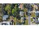 An aerial view of a well-maintained property featuring a lush, green lawn and mature trees at 4106 W Bay View Ave, Tampa, FL 33611