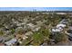 An aerial neighborhood view featuring mature trees, well-kept lawns, and the city skyline in the distance at 4106 W Bay View Ave, Tampa, FL 33611