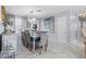 Elegant dining room with marble floors, mirrored accents, stylish furniture and chandelier lighting at 4106 W Bay View Ave, Tampa, FL 33611