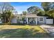 Inviting single-story home featuring a covered front porch and well-kept lawn at 4106 W Bay View Ave, Tampa, FL 33611