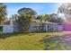 Well-maintained property with a lush front yard and mature tropical landscaping at 4106 W Bay View Ave, Tampa, FL 33611