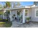 Cozy front porch with seating and decorative plants for welcoming curb appeal at 4106 W Bay View Ave, Tampa, FL 33611