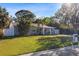 Beautifully landscaped front yard with mature trees surrounding a charming home at 4106 W Bay View Ave, Tampa, FL 33611