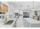 Modern kitchen featuring sleek countertops, pendant lights, stainless steel appliances, and white and gray cabinetry at 4106 W Bay View Ave, Tampa, FL 33611