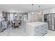 Open-concept kitchen and dining area with marble flooring, modern appliances, and stylish furniture at 4106 W Bay View Ave, Tampa, FL 33611