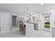 Bright kitchen featuring white cabinetry, marble floors, a large island with seating, and stainless steel appliances at 4106 W Bay View Ave, Tampa, FL 33611