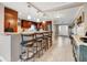 Open kitchen with stainless steel appliances, breakfast bar, and pendant lighting at 6023 Ambassador Dr, Tampa, FL 33615