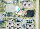Aerial view of community pool, tennis courts, and surrounding residences at 6262 142Nd Ave # 506, Clearwater, FL 33760