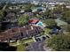 A birds eye view of the community's pool, pond and tennis courts surrounded by lush greenery at 6262 142Nd Ave # 506, Clearwater, FL 33760