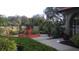 Well maintained grounds with a flowerbed, sidewalks, and palm trees at the community entrance at 6262 142Nd Ave # 506, Clearwater, FL 33760