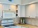 Well-lit kitchen featuring white appliances, granite countertops, and decorative tile backsplash at 6262 142Nd Ave # 506, Clearwater, FL 33760