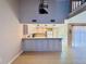 Spacious kitchen with a breakfast bar island, pendant lights, and tile floors at 6262 142Nd Ave # 506, Clearwater, FL 33760