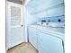 Well-lit laundry room with a white washer and dryer at 6262 142Nd Ave # 506, Clearwater, FL 33760