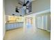 Open-concept living space with a vaulted ceiling, tile flooring, and sliding glass doors at 6262 142Nd Ave # 506, Clearwater, FL 33760