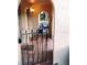 Arched entry to a tiled patio with an ornate gate leading to an outdoor seating area at 6262 142Nd Ave # 506, Clearwater, FL 33760