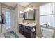 Bathroom with dark vanity, a white countertop, and a mirror at 7634 Nottinghill Sky Dr, Apollo Beach, FL 33572