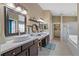 Bright bathroom featuring a double vanity, vessel sinks, and a large walk-in closet at 7634 Nottinghill Sky Dr, Apollo Beach, FL 33572