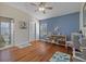 bedroom with connecting bathroom, hardwood floors and bright blue accent wall at 7634 Nottinghill Sky Dr, Apollo Beach, FL 33572